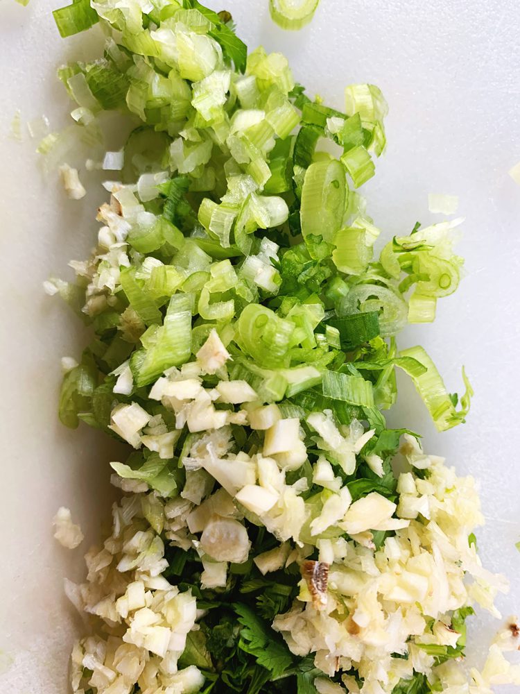 Minced green onions, garlic, and cilantro stems