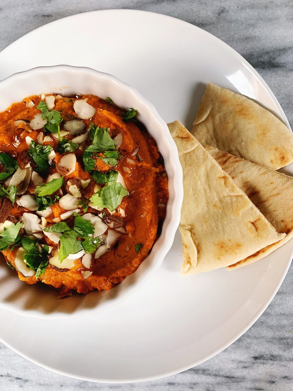 Roasted Red Pepper Hummus with Harissa, sliced almonds, and cilantro