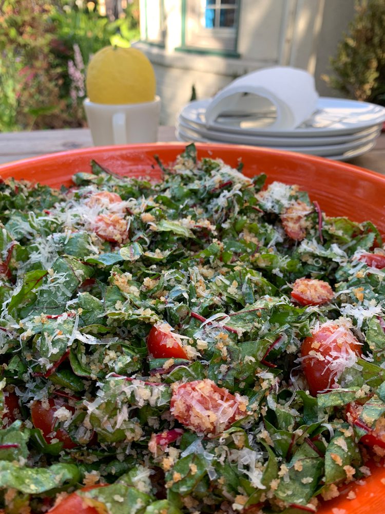 Swiss Chard salad with breadcrumbs, lemon viniagrette, cherry tomatoes, and Parmesan cheese