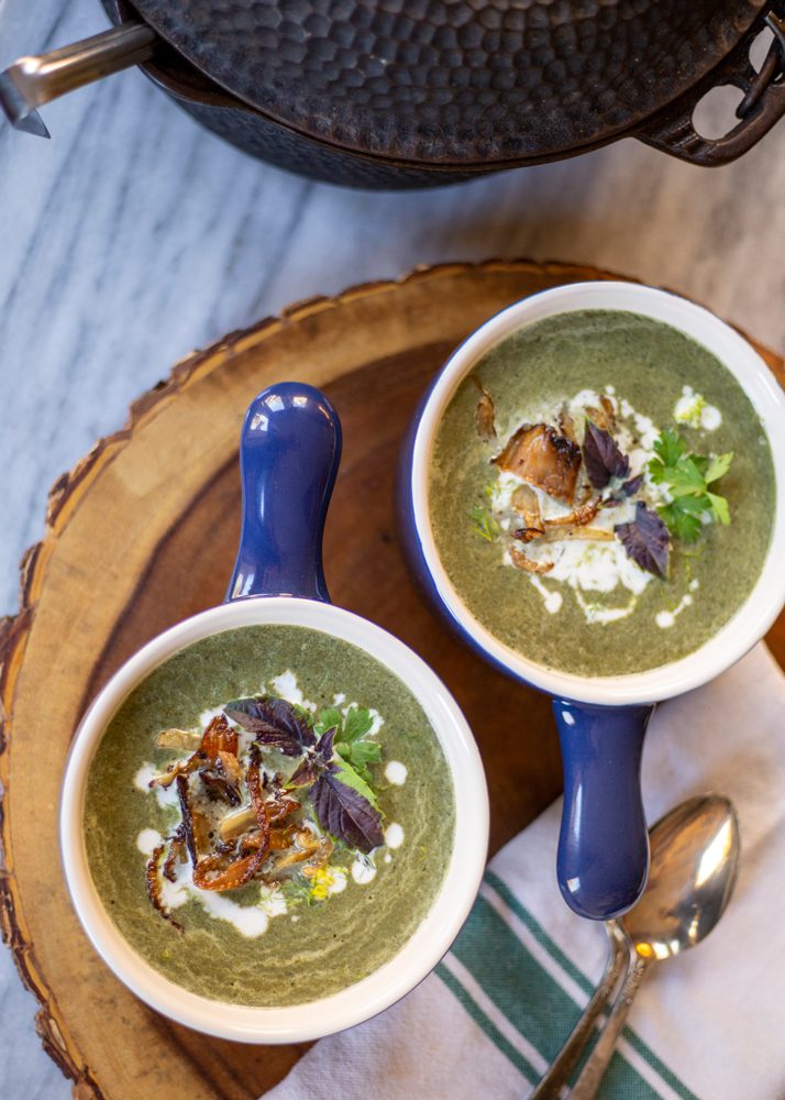 Fennel Soup | Two bowls of blended fennel soup with parsley, basil, and roasted fennel on top