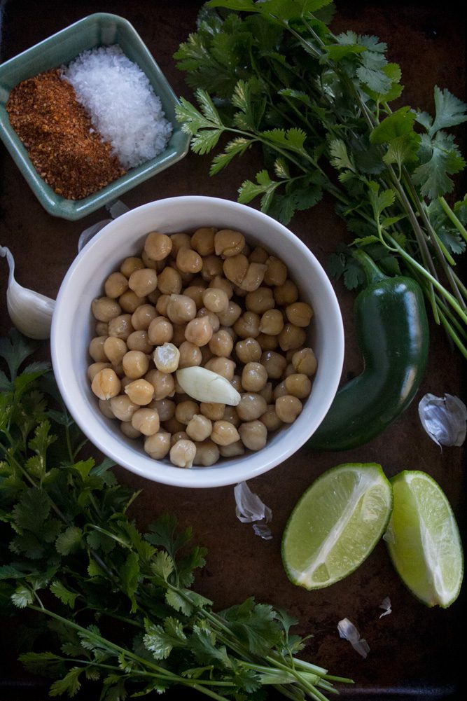 Raw ingredients for Taco Hummus | Garbanzo beans, taco seasoning, salt, cilantro, jalapeno, lime, and garlic clove