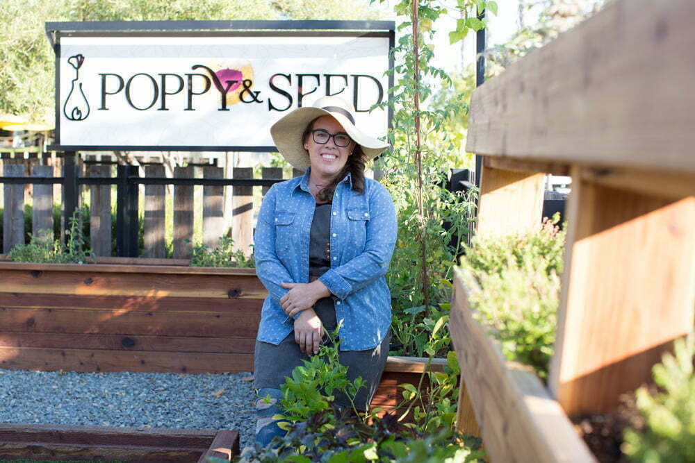 Ashley Irene, the Heirloom Potager, wearing garden hat in the Poppy & Seed chef's garden | Photo by Nicole Kent