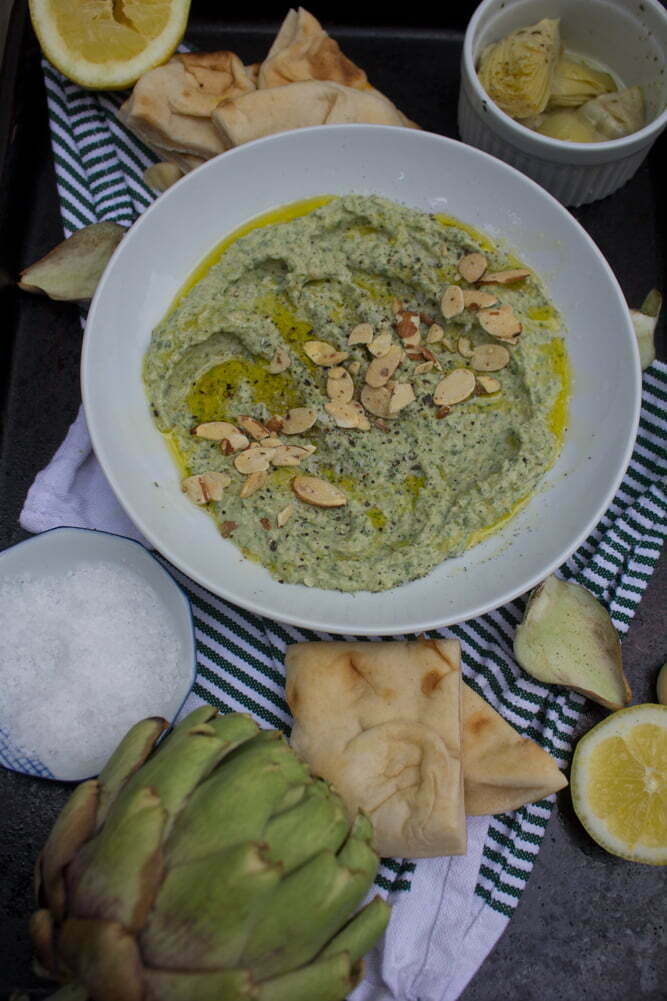 Spinach Artichoke Hummus | Garnished with sliced almonds, olive oil, salt + pepper