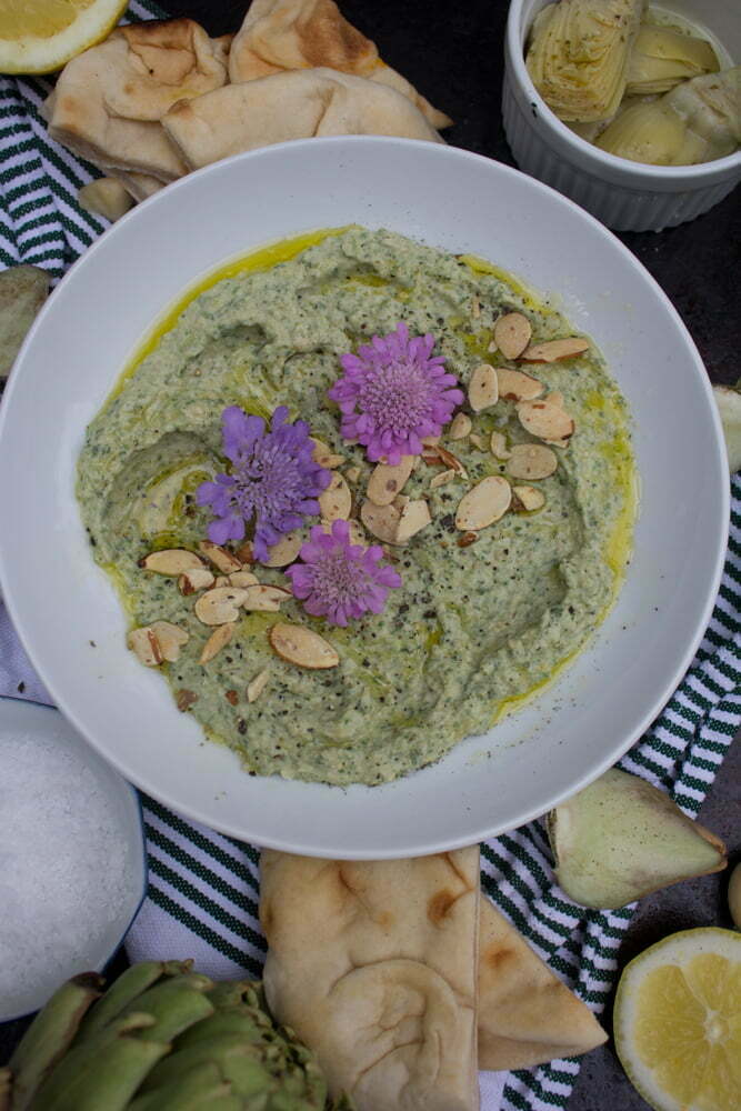 Spinach Artichoke Hummus | garnished with sliced almonds and olive oil