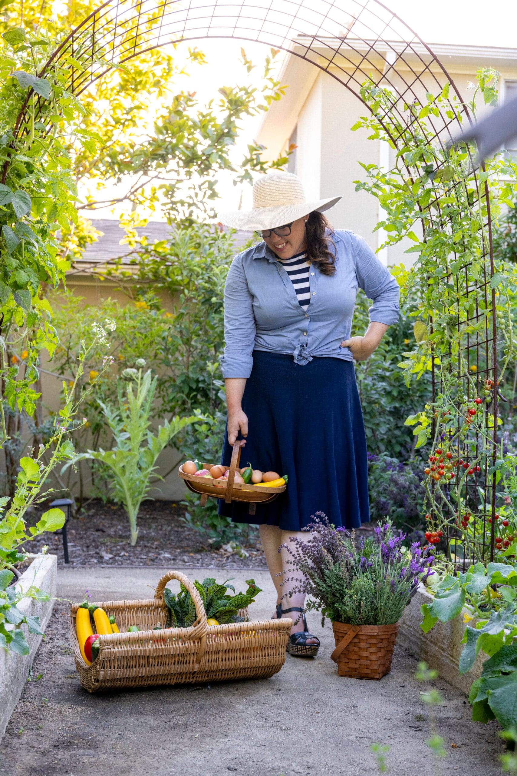 Ashley Irene in a client summer garden filled with trellis options for vertical growing