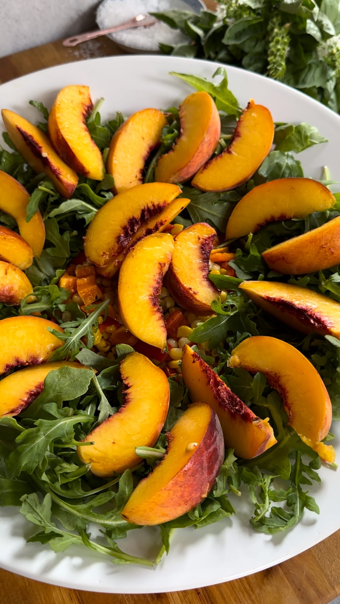 Plated Summer Corn, Sweet Pepper, and Peach Salad with Arugula